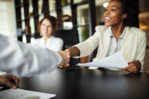 Client shaking hands with business attorney